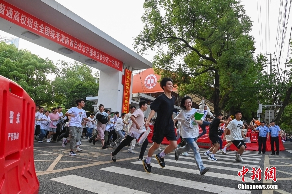 资料图：湖南省2023年高考结束，考生步出考场与亲友庆祝。中新社记者 杨华峰 摄